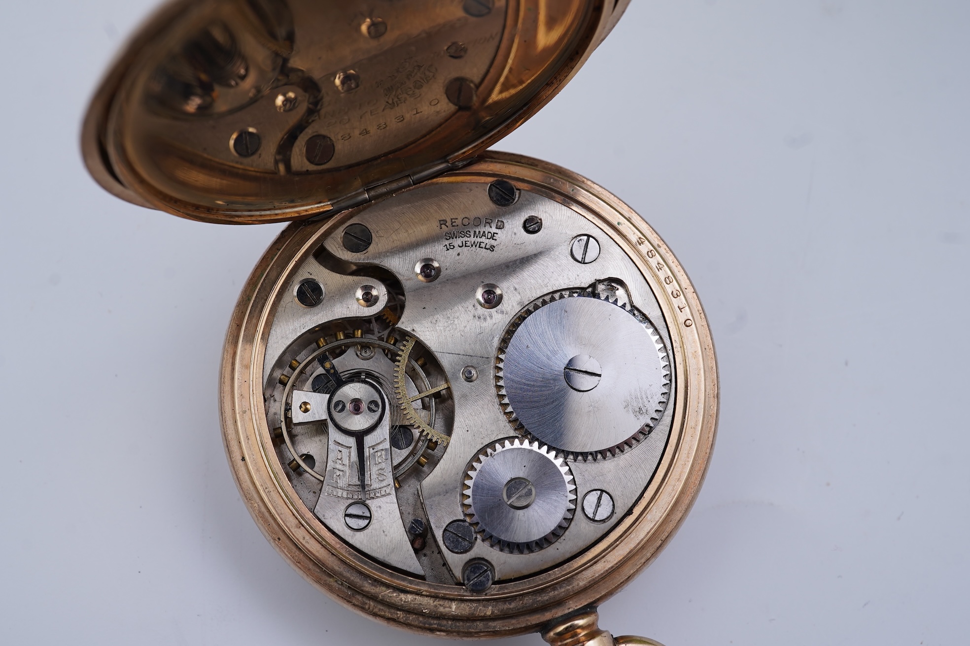An amethyst fob seal, a gold Albert chain, and a pocket watch